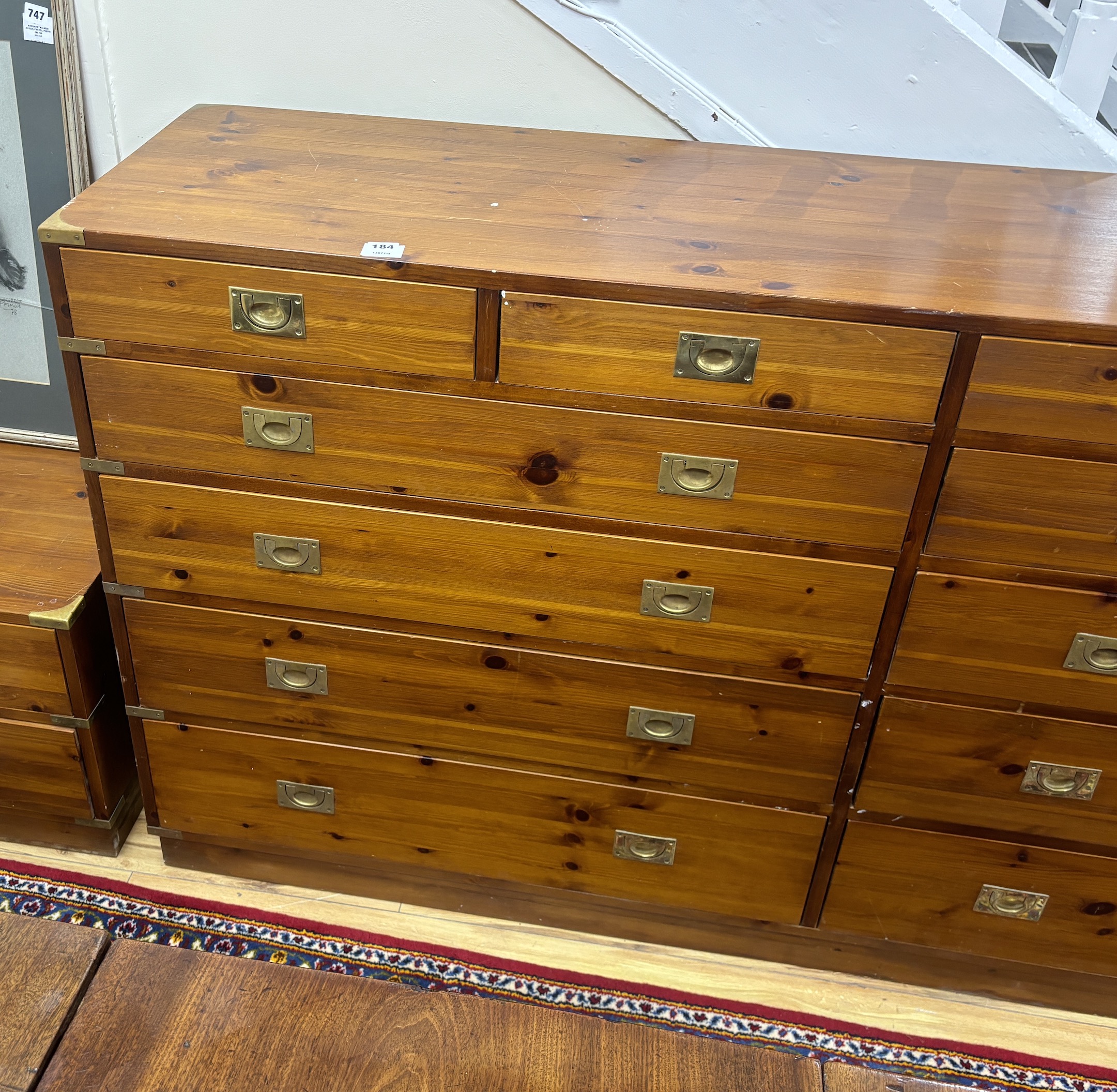 A large military style brass mounted pine twelve drawer chest, width 183cm, depth 46cm, height 97cm